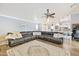 Spacious living room with hardwood floors, a large sectional sofa, and an open layout at 2431 E Laurel St, Mesa, AZ 85213