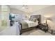 Main bedroom with a wooden bed frame, a ceiling fan, and view of the en suite bathroom at 2431 E Laurel St, Mesa, AZ 85213