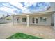 Covered outdoor patio with travertine tile flooring, pillars and access to the backyard, perfect for entertaining at 2431 E Laurel St, Mesa, AZ 85213