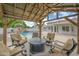 Backyard with a freeform pool, rock waterfall feature, covered seating area, and a lush landscape, creating a private paradise at 2431 E Laurel St, Mesa, AZ 85213