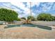 A large pool with a rock waterfall feature and mature landscaping creating a private oasis at 2431 E Laurel St, Mesa, AZ 85213