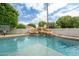 Refreshing swimming pool with a rock waterfall feature and mature landscaping, perfect for relaxing and enjoying outdoor living at 2431 E Laurel St, Mesa, AZ 85213