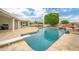 A beautiful pool with a diving board, rock waterfall, and a pergola with outdoor seating at 2431 E Laurel St, Mesa, AZ 85213