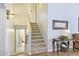 Interior staircase with carpeted steps, natural lighting, and hallway leading to bathroom at 2431 E Laurel St, Mesa, AZ 85213