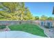 Spacious backyard with well-maintained lawn, mature trees, and block wall at 329 S Marin Dr, Gilbert, AZ 85296