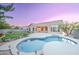 Evening shot of a sparkling private pool and manicured lawn, perfect for relaxation at 329 S Marin Dr, Gilbert, AZ 85296