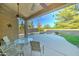 Covered patio with seating area offers an outdoor relaxation area with pool views at 329 S Marin Dr, Gilbert, AZ 85296