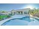 Beautiful backyard featuring a private pool, covered patio, palm trees, and lush green lawn at 329 S Marin Dr, Gilbert, AZ 85296