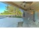 Covered patio boasts ceiling fans and shade with view of the backyard and pool at 329 S Marin Dr, Gilbert, AZ 85296
