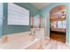 Bright bathroom featuring a soaking tub, separate shower, and stylish tile flooring at 329 S Marin Dr, Gilbert, AZ 85296