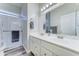 Bright bathroom features a double sink vanity, large mirror, and glass enclosed shower at 329 S Marin Dr, Gilbert, AZ 85296