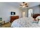 Cozy bedroom featuring a ceiling fan, dresser, and a comfortable bed with soft bedding at 329 S Marin Dr, Gilbert, AZ 85296