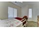 Light bedroom with a window, comfortable bed, and vintage-style furniture at 329 S Marin Dr, Gilbert, AZ 85296