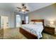 Main bedroom with ceiling fan, archway, and en-suite bathroom at 329 S Marin Dr, Gilbert, AZ 85296