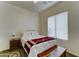 Comfortable bedroom with a soft rug, ceiling fan, window, and ample natural light at 329 S Marin Dr, Gilbert, AZ 85296