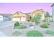 Inviting single-story home featuring a three-car garage, desert landscaping and solar panels at 329 S Marin Dr, Gilbert, AZ 85296