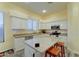 Well-lit kitchen featuring an island with seating, white cabinets and granite countertops at 329 S Marin Dr, Gilbert, AZ 85296
