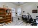 Home office with bright natural light, wood bookcase and functional desk setup at 329 S Marin Dr, Gilbert, AZ 85296