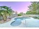 Beautiful backyard pool with palm trees and desert landscaping at dusk at 329 S Marin Dr, Gilbert, AZ 85296