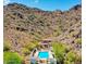 Aerial view of a community pool nestled in a desert mountain landscape at 3800 E Lincoln Dr # 37, Phoenix, AZ 85018