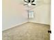 Bright bedroom showcasing neutral carpet, a ceiling fan, and a window, creating a clean and inviting space at 4028 E Mountain Sage Dr, Phoenix, AZ 85044
