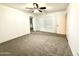 Spacious bedroom with neutral carpet, ceiling fan, and ample natural light, offering a cozy atmosphere at 4028 E Mountain Sage Dr, Phoenix, AZ 85044