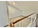 Loft view of an open space with neutral carpet and railing overlooking a staircase and living area at 4028 E Mountain Sage Dr, Phoenix, AZ 85044