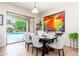 Charming dining area with seating for six and sliding glass doors leading to the pool area at 404 E Coconino Pl, Chandler, AZ 85249
