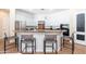 Modern kitchen with stainless steel appliances, bar-style seating, and ample counter space at 404 E Coconino Pl, Chandler, AZ 85249