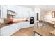 Bright kitchen boasts granite countertops, stainless steel appliances, tiled floor, and white cabinetry at 404 E Coconino Pl, Chandler, AZ 85249