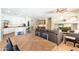 Open-concept living room showcasing dining table, sofa, entertainment center, and kitchen with breakfast bar at 404 E Coconino Pl, Chandler, AZ 85249