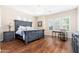 Spacious main bedroom with a large bed, wood floors, and plantation shutters at 404 E Coconino Pl, Chandler, AZ 85249