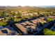 Expansive aerial view of a luxury home with desert landscape, solar panels, and mountain views at 41715 N River Bend Rd, Phoenix, AZ 85086