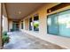 Covered back patio with travertine flooring overlooking landscaped backyard at 41715 N River Bend Rd, Phoenix, AZ 85086