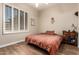 Bedroom features a wood floor, plantation shutters, and a queen sized bed at 41715 N River Bend Rd, Phoenix, AZ 85086