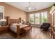 Bedroom with wood floors, natural light, and a king-sized bed at 41715 N River Bend Rd, Phoenix, AZ 85086