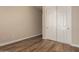 A simple bedroom featuring a closet, wood-look flooring, and neutral walls at 41715 N River Bend Rd, Phoenix, AZ 85086