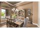 Elegant dining room with chandelier, wood floors, and decorative hutch at 41715 N River Bend Rd, Phoenix, AZ 85086