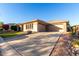 Lovely home featuring a spacious driveway, three-car garage, and desert landscaping with flowering plants at 41715 N River Bend Rd, Phoenix, AZ 85086