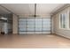 Spacious garage with epoxy flooring, overhead lighting, and convenient window placement at 41715 N River Bend Rd, Phoenix, AZ 85086