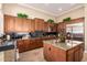 Spacious kitchen featuring granite countertops, stainless steel refrigerator, and wooden cabinets at 41715 N River Bend Rd, Phoenix, AZ 85086