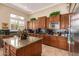 Spacious kitchen features wooden cabinetry, stone countertops, and stainless steel appliances at 41715 N River Bend Rd, Phoenix, AZ 85086