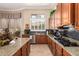 Open kitchen featuring granite counters, gas cooktop, stainless steel appliances, and a garden view at 41715 N River Bend Rd, Phoenix, AZ 85086