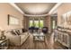 Bright living room with large windows, hardwood floors, comfortable sofa, and grand piano at 41715 N River Bend Rd, Phoenix, AZ 85086