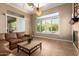 Cozy living room featuring tile floors, fireplace, and a view to the outdoor space at 41715 N River Bend Rd, Phoenix, AZ 85086