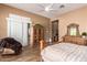Spacious bedroom features wood floors, a dressing table, and a patio door at 41715 N River Bend Rd, Phoenix, AZ 85086
