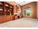 Office with custom built-in bookshelves and a large window offering natural light at 41715 N River Bend Rd, Phoenix, AZ 85086