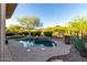 Tranquil backyard with a pool, fountain, and desert landscaping, perfect for outdoor enjoyment at 41715 N River Bend Rd, Phoenix, AZ 85086