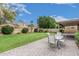 This home features a large backyard, patio and green lawn for outdoor enjoyment at 4620 E Desert Cactus St, Phoenix, AZ 85032