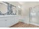 Bright bathroom with double vanity, soaking tub, glass enclosed shower, and tile accent wall at 4620 E Desert Cactus St, Phoenix, AZ 85032